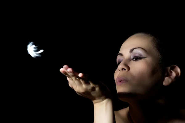 stock image Beautiful women blows a feather