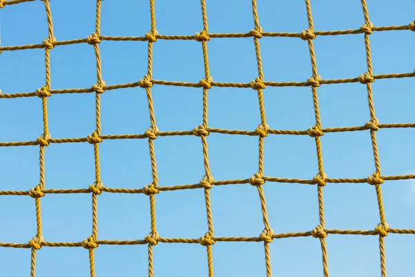 stock image Yellow net against the blue sky