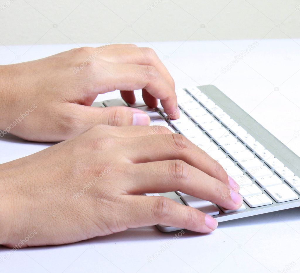 Hands typing on the computer keyboard