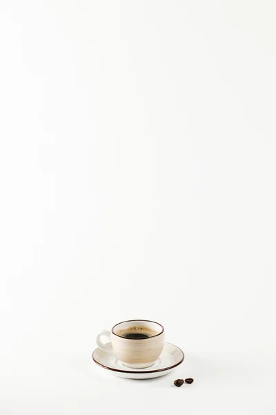 Light colored cup on the white background — Stock Photo, Image