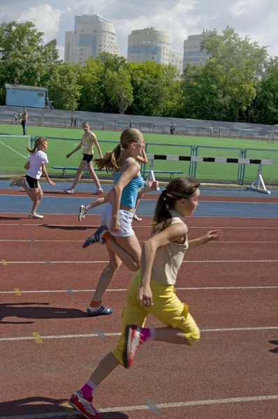 Compétition régionale en champion d'athlétisme junior de l'Oural, jeunes athlètes féminines qui courent autour du stade Dynamo . — Photo