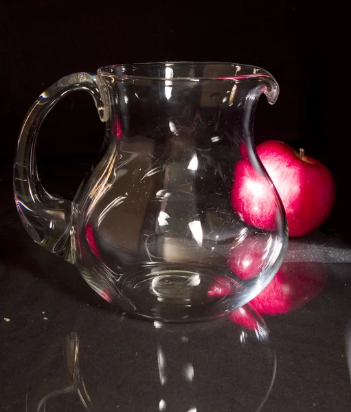 Glass pitcher jug on black background — Stock Photo, Image