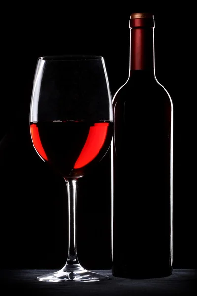 stock image Red wine bottle and glass