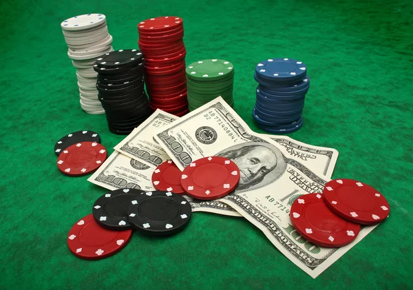 Gambling chips och dollarn räkningar över grön filt — Stockfoto