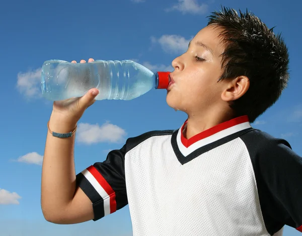 Thirsty boy drinking water outdoors — Stock Photo, Image