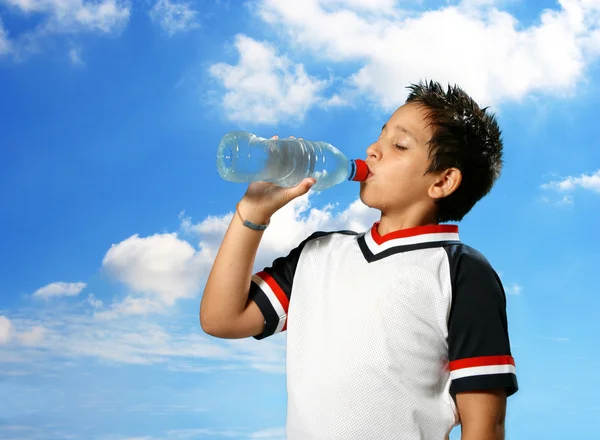 Thirsty boy drinking water outdoors — Stock Photo, Image