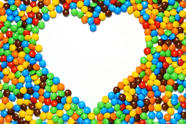 White heart shape with candy background — Zdjęcie stockowe