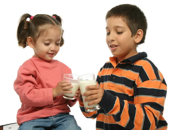 Irmão e irmã bebendo leite — Fotografia de Stock