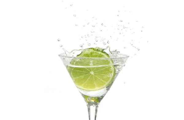 stock image Lime splashing into a cocktail glass