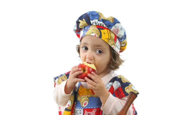 Little girl cooking dressed as a chef — Stock Photo, Image
