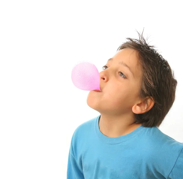 Boy blowing a pink bubble gum — Stock Photo, Image