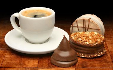 Cup of coffee and sweet chocolates clipart