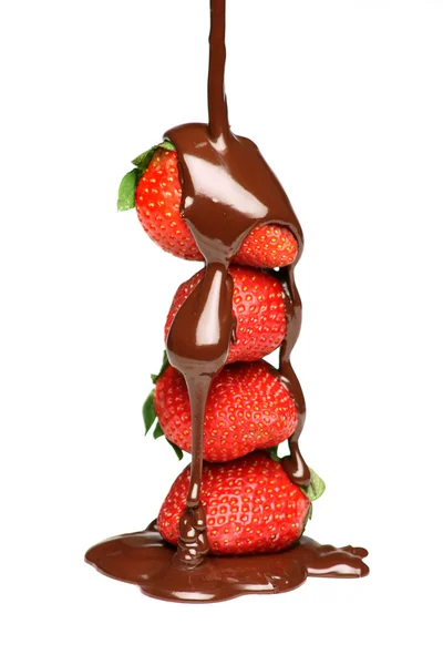 Gieten van gesmolten chocolade over aardbeien — Stockfoto