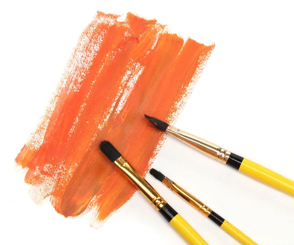 Three brushes and strokes over white — Stock Photo, Image