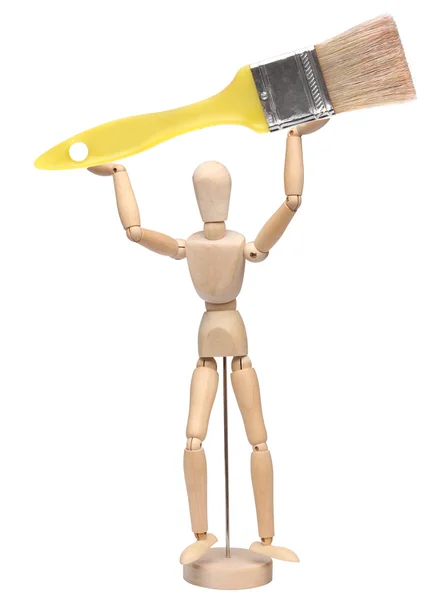Wood mannequin holding a brush over white — Stock Photo, Image