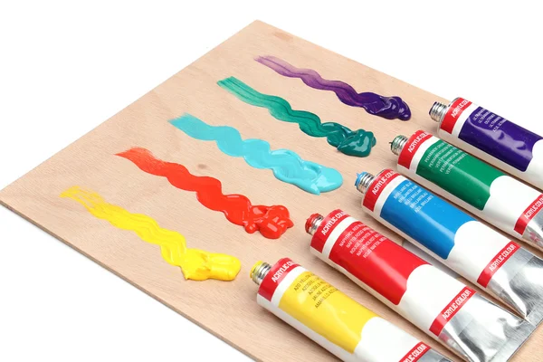 Five paint tubes over a pallete — Stock Photo, Image