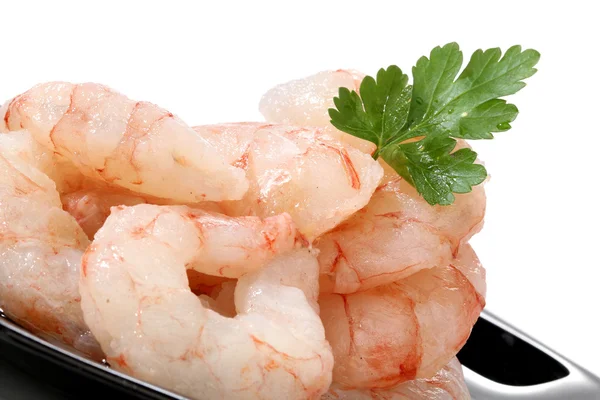 stock image Pile of prawns over a black dish