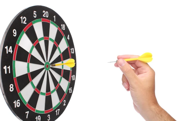 Hand throwing a yellow dart over white — Stock Photo, Image