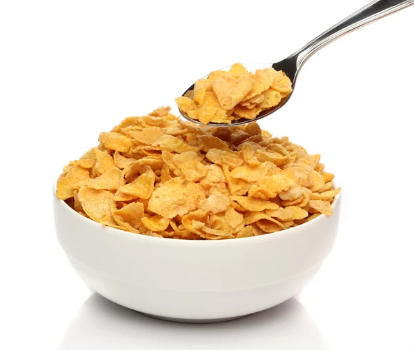 Cornflakes on a spoon over a bowl — 图库照片