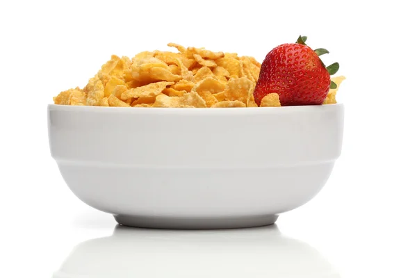 Pile of cornflakes on a bowl over white background — Stock Photo, Image
