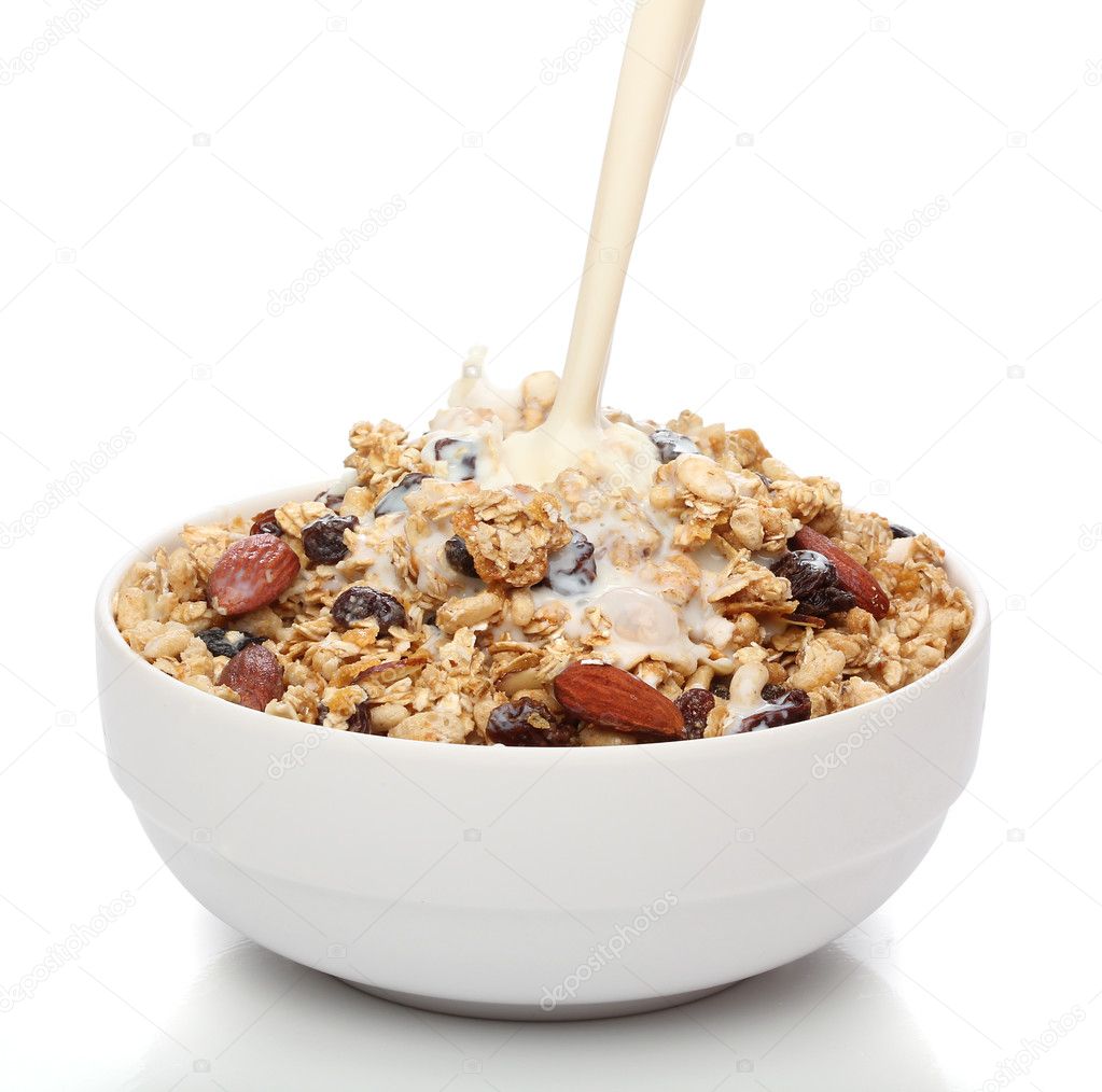 Pouring milk into a bowl with granola cereal
