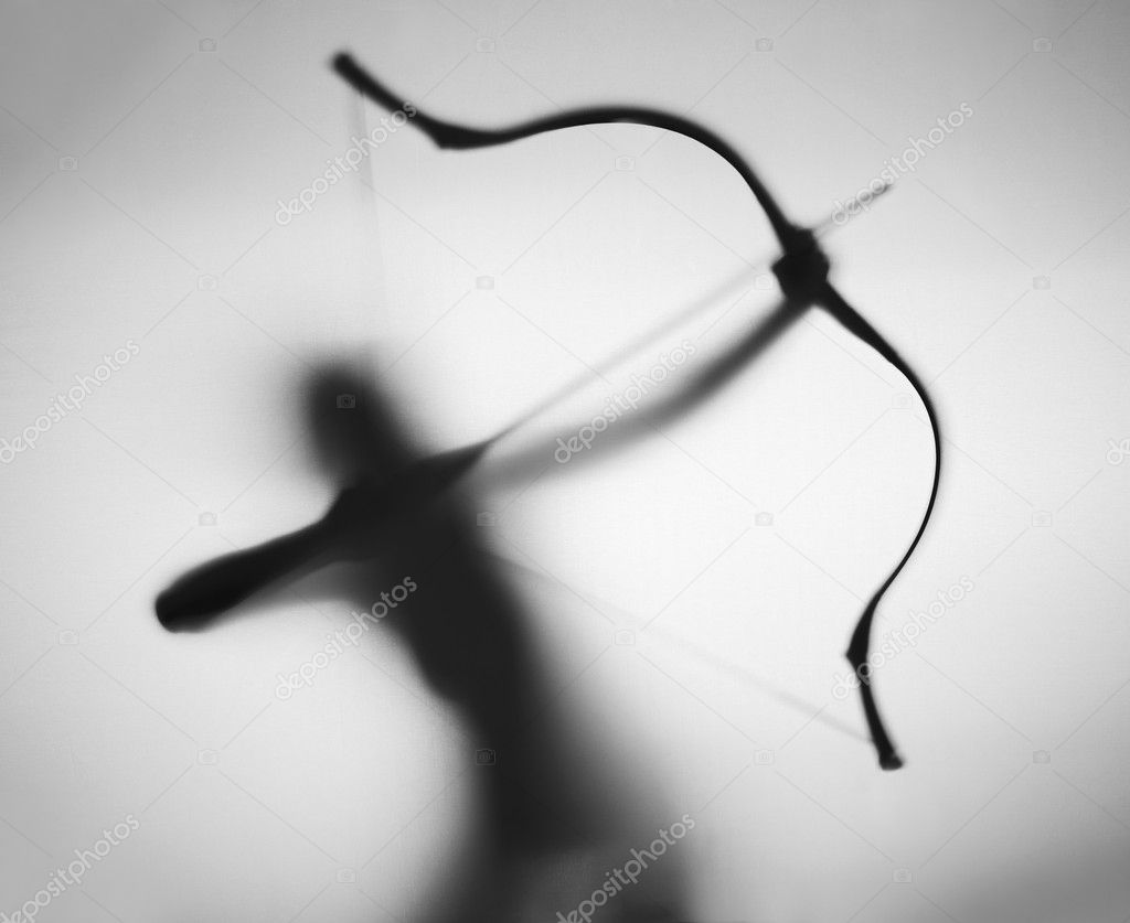Female archer prepares to shoot, silhouette