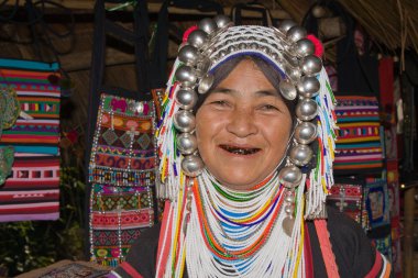 Lahu old woman with black teeth because of chewing herbs. clipart