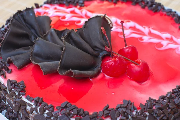 stock image Chocolate cake with a red cherry