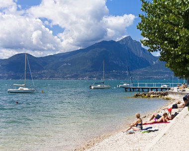 Beach of Lake Garda at Torri del Benaco clipart