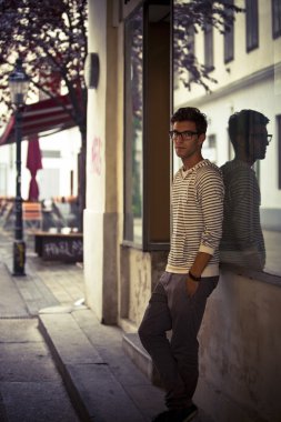 Cool young man in urban setting - Low Key clipart