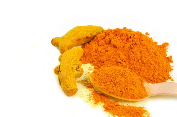 Powdered turmeric in wooden spoon — Stock Photo, Image