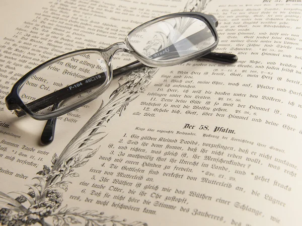 stock image Glasses on the thick old book.