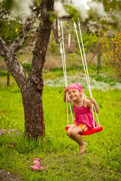 Little girl with swing. — Stock Photo, Image