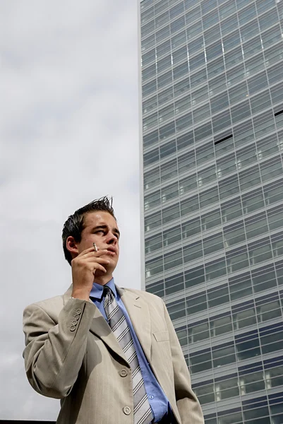 Businessman smoking cigarette — Stock Photo, Image