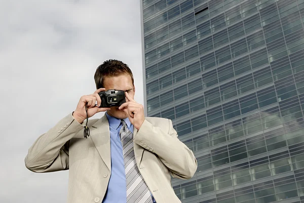 Young businessman with camera — Stock Photo, Image