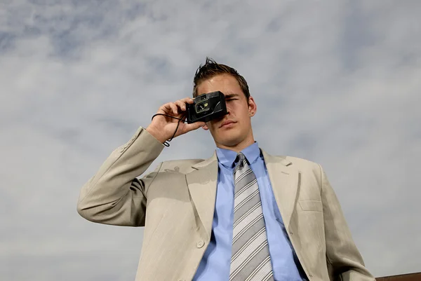 stock image Young businessman with camera