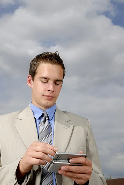 Young businessman with PDA — Stock Photo, Image