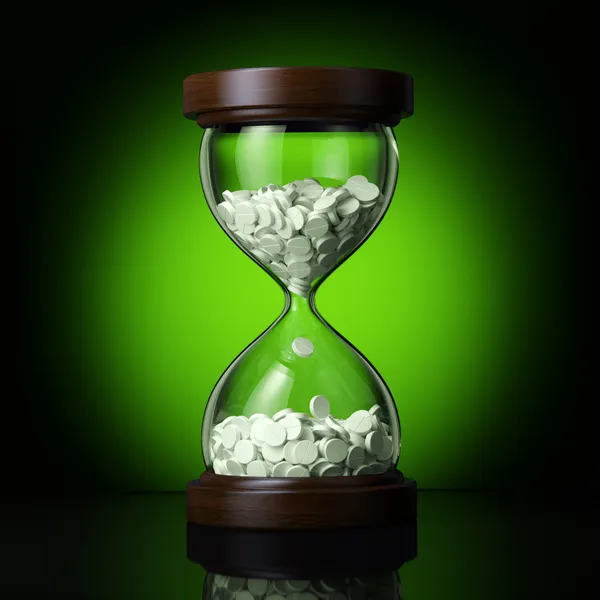 Old sand clock with pills — Stock Photo, Image