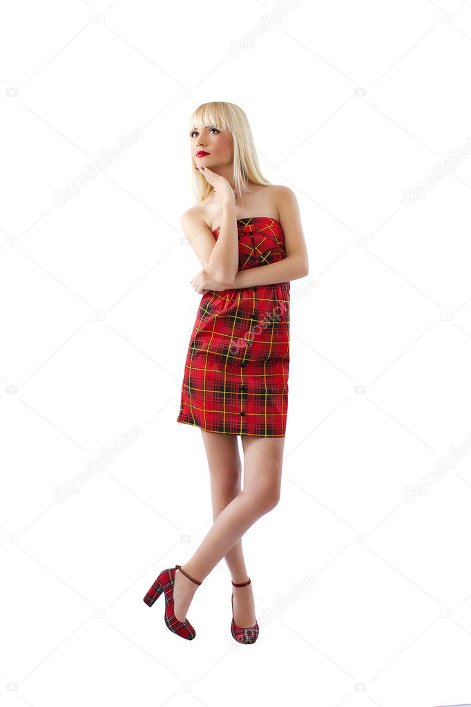 Beautiful young blonde girl posing in red dress