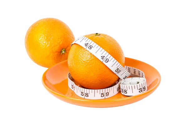 Ovoce pomeranče měření páskou na oranžové deska — Stock fotografie