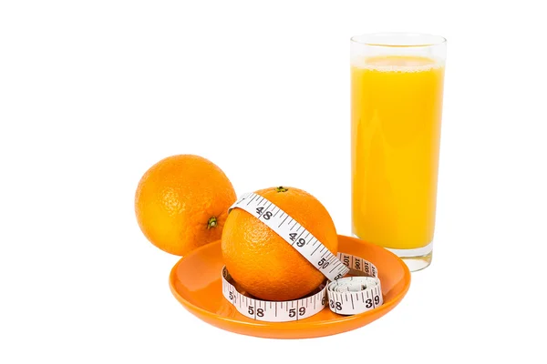 stock image Oranges with measurement tape with glass of orange juice