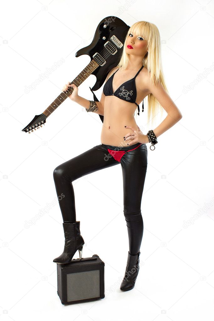 Sexy blonde woman in red thong posing with black electric guitar