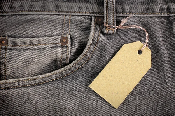 Denim jeans with price tag — Stock Photo, Image