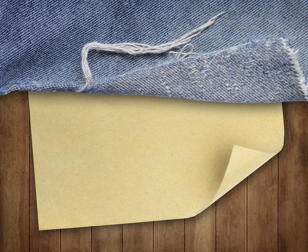 Brown wood texture with paper and jeans — Stock Photo, Image