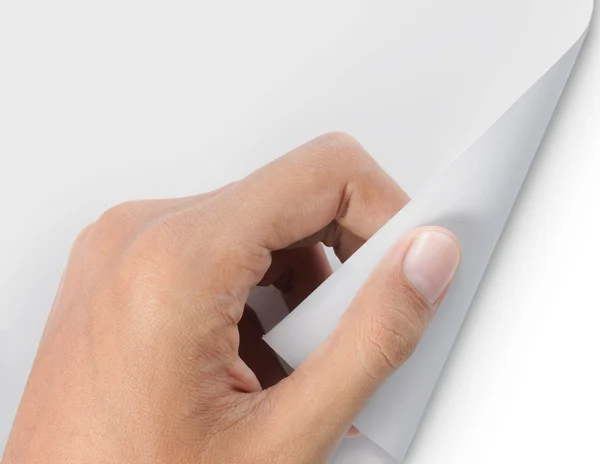 Hand turning page of white paper — Stock Photo, Image
