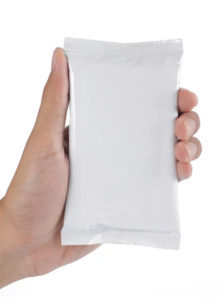 Mão segurando embalagem de plástico — Fotografia de Stock