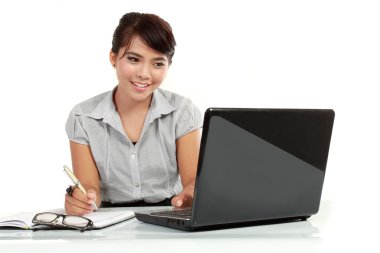 Business woman working on laptop computer clipart