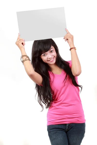 Portrait of a cute young woman holding a blank card up on her fa — Stock Photo, Image
