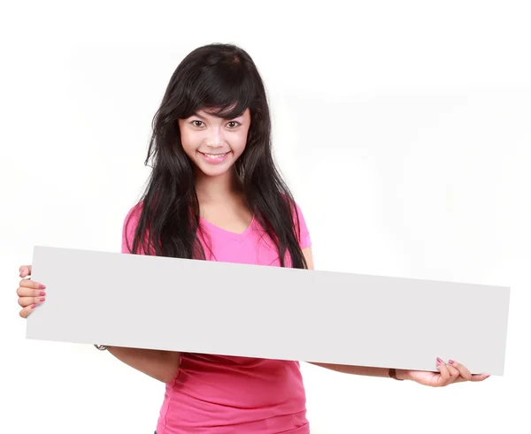 Cute young woman holding a long blank board for your text againt — Stock Photo, Image