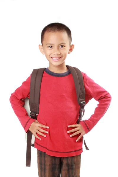 Portrait of boy with backpack smiling against white — Stock Photo, Image